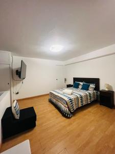 a bedroom with a bed and a television in it at Duplex en primer piso - A media Cuadra Embajada USA in Lima