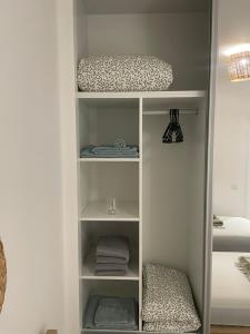 a white closet with towels and a bed at Ocean View Santa Filomena in Mindelo