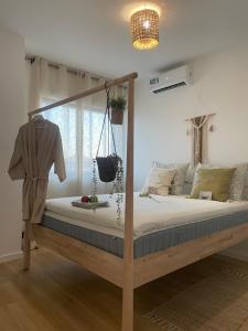 a bedroom with a wooden bed with a swing at Ocean View Santa Filomena in Mindelo