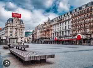 a city street with benches in front of buildings at Appartement au pied de la grand place in Brussels