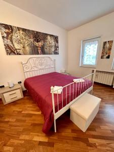a bedroom with a bed with a red bedspread at Brendon Suite in Brindisi