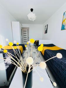 a bedroom with two beds with yellow and black at Guesthouse GreatHome in Karakol