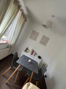 a small room with a table and two chairs at Chester Cottage in Frodingham