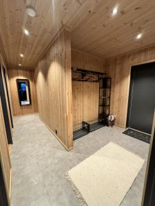a large room with wooden walls and a room with at Ny hytte, fantastisk utsikt rett ved Vestlia in Geilo