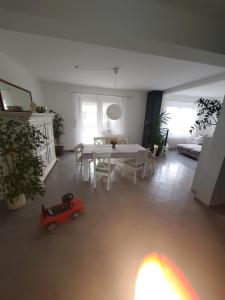 a living room with a table and a small toy car at Große 3 Zi Wohnung auf der Pferde Farm in Lahr-Dinglingen