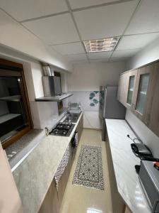 a kitchen with a sink and a stove top oven at Cozy Central Apartment in Sighetu Marmaţiei