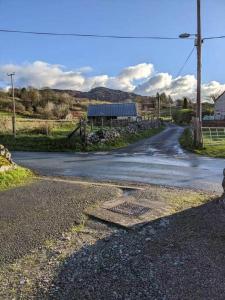 an empty road with a building on the side of it at 3 Tan Y Coed in Brynkir