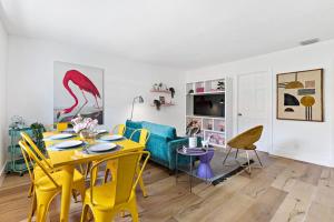 a living room with a yellow table and yellow chairs at Stylish 2 BR Condo - Free Parking on Premises in Fort Lauderdale
