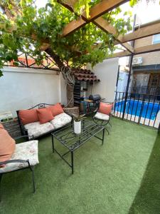 a patio with a couch and chairs and a table at Casa Guemes in Santiago