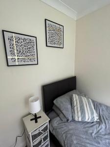 a bedroom with a bed and a table with a lamp at St James House in Scunthorpe