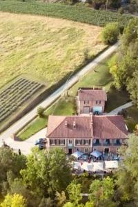 an aerial view of a farm house with a parking lot at La depandance de La Castella in Villafranca dʼAsti +14 photos