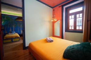 a bedroom with a bed and a window in it at Soul - moradia criativa in Vila Franca de Xira