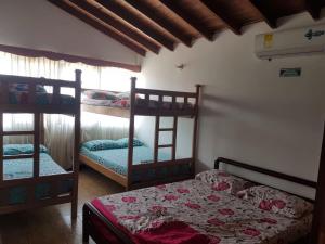 a bedroom with two bunk beds and a window at Casa frente al mar hasta 15 personas in Necoclí