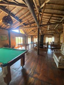 a large room with a pool table in it at Pousada Chalés Vale do Sol in Conceição da Ibitipoca