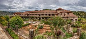 a large building with a garden in front of it at Teror Centro 2 in Teror
