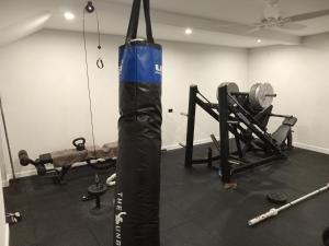 a gym with a punching bag and weights at Sanctuary Villa in Christ Church