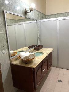 a bathroom with a sink and a large mirror at Meson la Esperanza in Lagos de Moreno