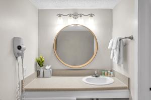 a bathroom with a sink and a mirror at Sands Harbor Resort and Marina in Pompano Beach +31 photos