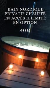 a bathtub with two lights on top of it at Coeur de ferme en Pévèle 