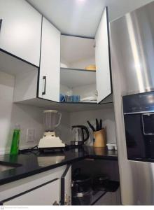 a kitchen with white cabinets and a blender on the counter at Cozy & Private Entire Basement in Winnipeg