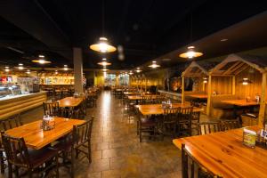 an empty restaurant with wooden tables and chairs at Great Wolf Lodge Grand Mound in Centralia