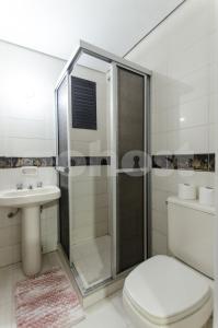 a bathroom with a shower and a toilet and a sink at Amazing Apartment Near La Costanera in Asunción