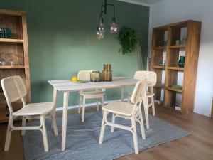 a dining room table with four chairs and a white table at Grünes Stüble Allgäuer Alpen in Sonthofen