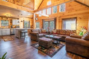 a large living room with couches and a kitchen at Downhill Lodge in Lake Placid