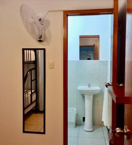 a bathroom with a sink and a mirror at Piccolo Bed & Breakfast in Tarapoto