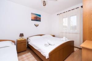 Postel nebo postele na pokoji v ubytování Apartments Miljenka