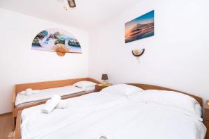 Postel nebo postele na pokoji v ubytování Apartments Miljenka