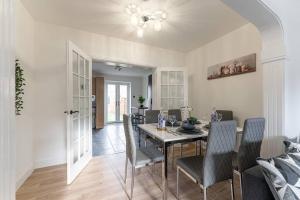 a dining room with a table and chairs at Modern House, Sleeps 5 in Central Coventry in Coventry