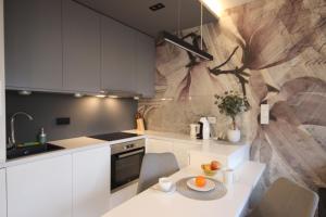 a kitchen with a table with a bowl of fruit on it at VIVA LILA Apartment, FREE PARKING, close to Vistula River - by Homelike Krakow in Krakow