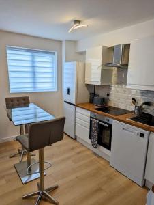 a kitchen with a table and a chair in it at Thurrock-Grays Cosy 2 bed Flat easy access to London in Grays Thurrock