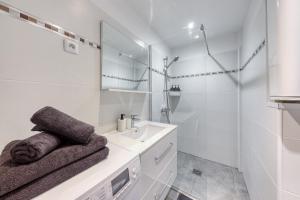 a white bathroom with a sink and a shower at Central 3 - 10 min Paris - 30 min Disney - Free Parking - 5 min RER A in Fontenay-sous-Bois +24 photos