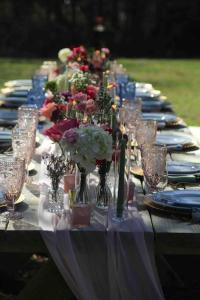 a long table with glasses and flowers on it at Colonial Chic - 3BR home, VA wine country near Harpers Ferry in Purcellville