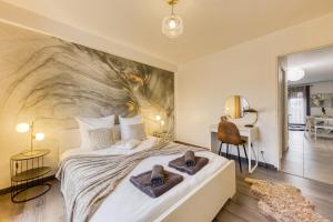 a bedroom with a large bed with towels on it at Central 5 - 10 min Paris - 30 min Disney - Free Parking - 5 min RER A in Fontenay-sous-Bois +28 photos