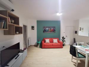 a living room with a red couch and a table at Colour House in Rome