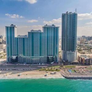 a view of a city with tall buildings and the ocean at Amazing Beachfront Holiday Home in Ajman 
