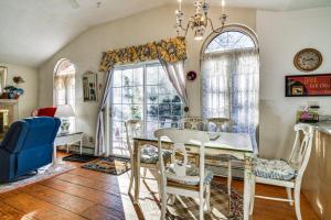 a dining room with a table and chairs and windows at Glen Cottage with Deck and River View 3 Mi to Skiing! in Glen