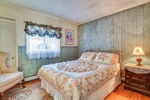 a bedroom with a bed and a chair and a window at Glen Cottage with Deck and River View 3 Mi to Skiing! in Glen