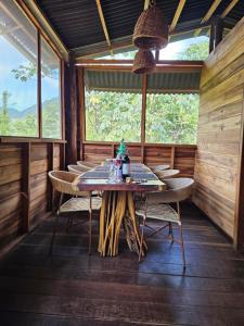 a wooden dining room with a table and chairs at La Casa Del Mono in Minca