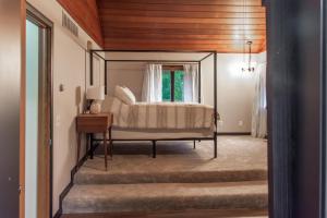 a bedroom with a bed with a mirror at Dogwood Retreat with big pool! in Warsaw