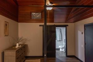 a living room with a wooden ceiling and a door at Dogwood Retreat with pool in Warsaw