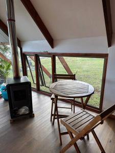 a living room with a stove and a table and a chair at Terevaka Lodge in Hanga Roa