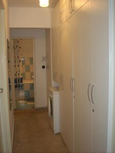 a hallway with white cabinets in a room at Black Sea Coast Apartment in Constanţa