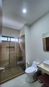 a bathroom with a shower and a toilet and a sink at Sweet Tulum 202 in Tulum