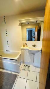 a bathroom with a sink and a mirror at Baker Street 2 Bed Apartment in London