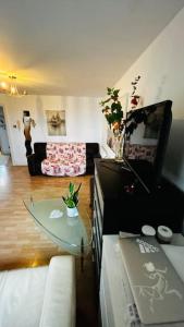 a living room with a couch and a glass table at Baker Street 2 Bed Apartment in London