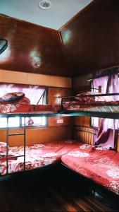 a room with three bunk beds in a bus at Royal Belum Mystical in Gerik